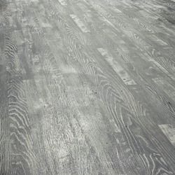 A close up of luxury vinyl plank grey flooring that looks like wood