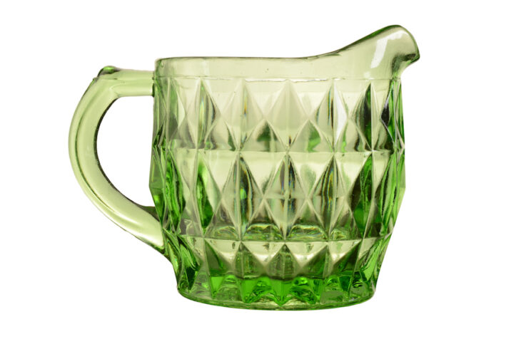 A green Depression Glass small pitcher 